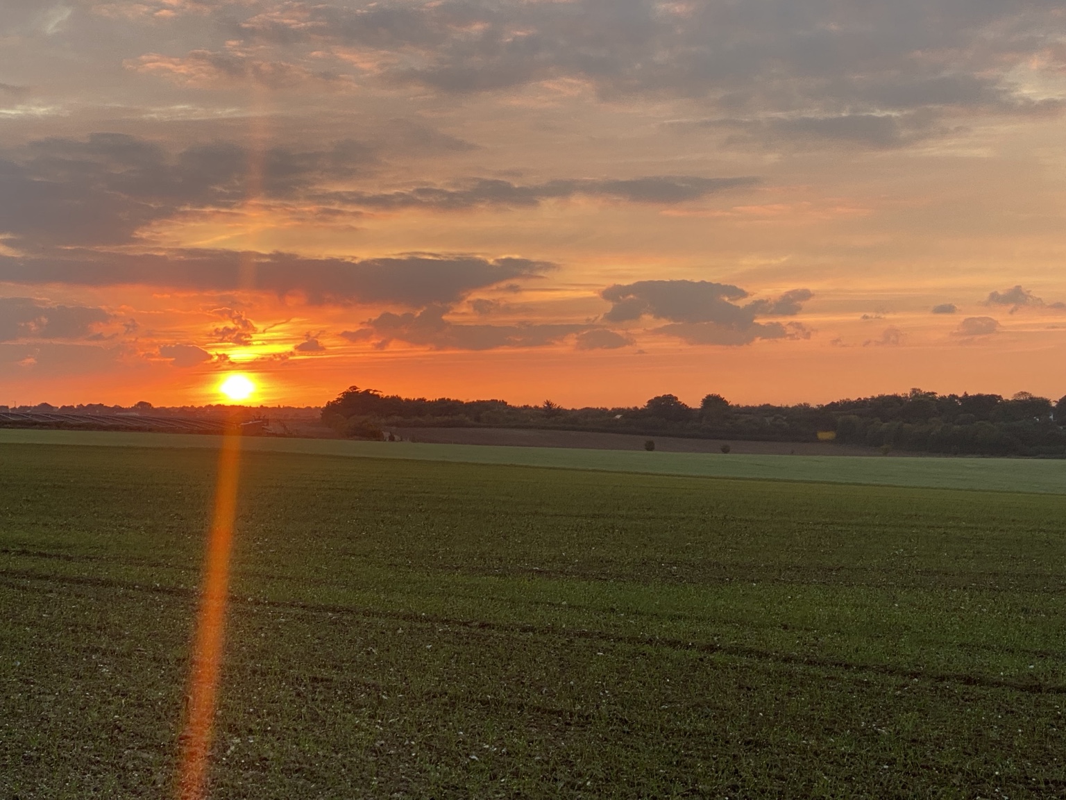 The sun dropping over the fields